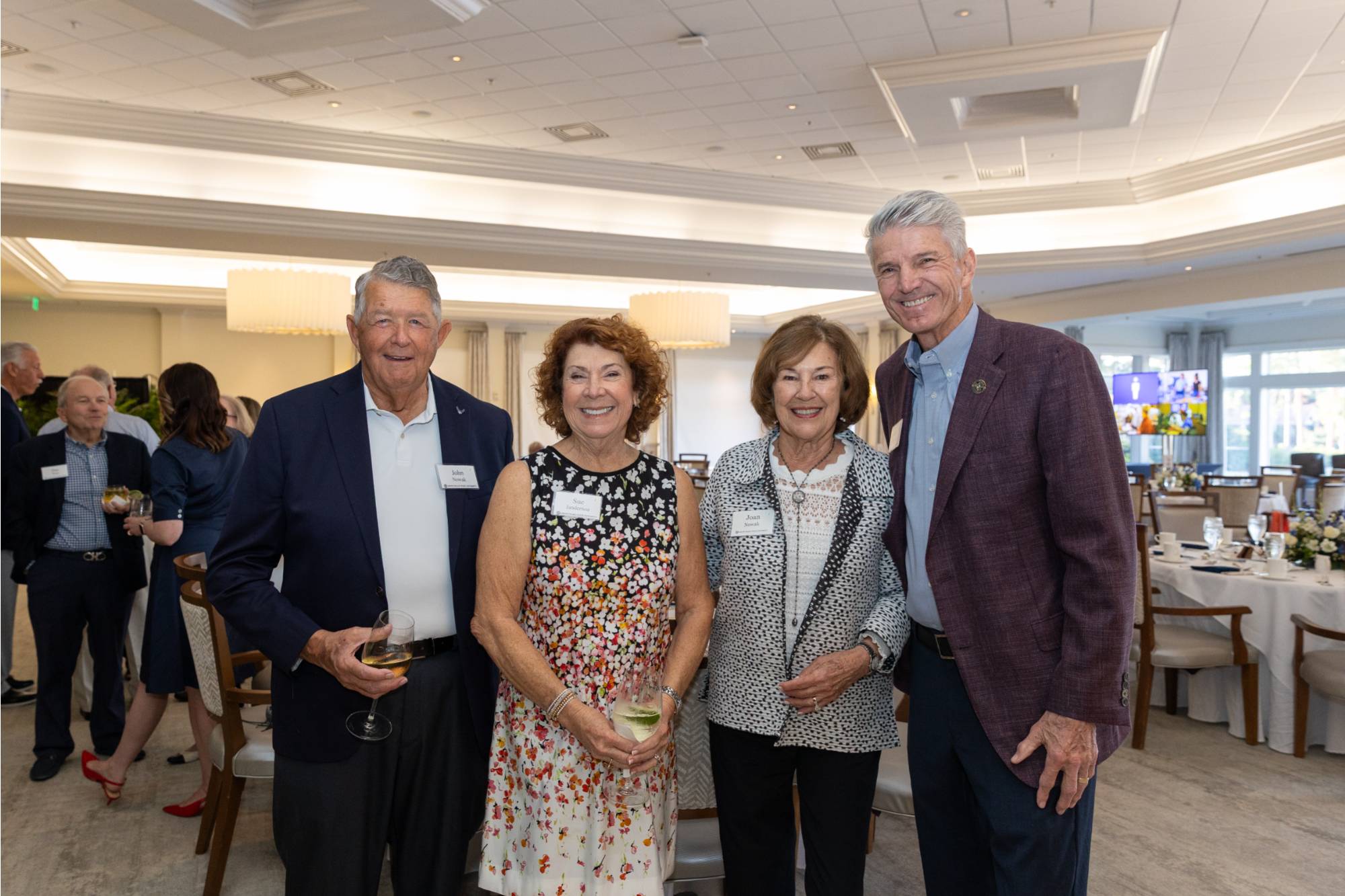 Four event attendees smiling for photo